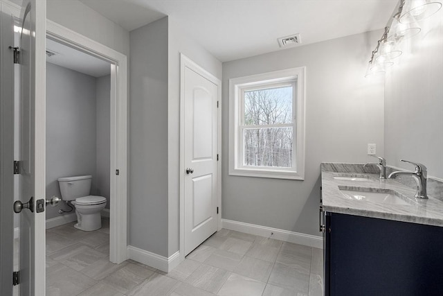 bathroom with vanity and toilet