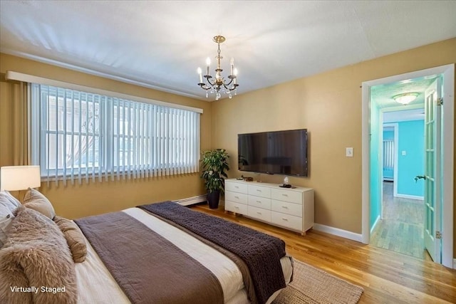 7 Wilbur Ct, Saugus, MA 01906 - bedroom with a chandelier, light wood-type flooring, baseboards, and a baseboard heating unit