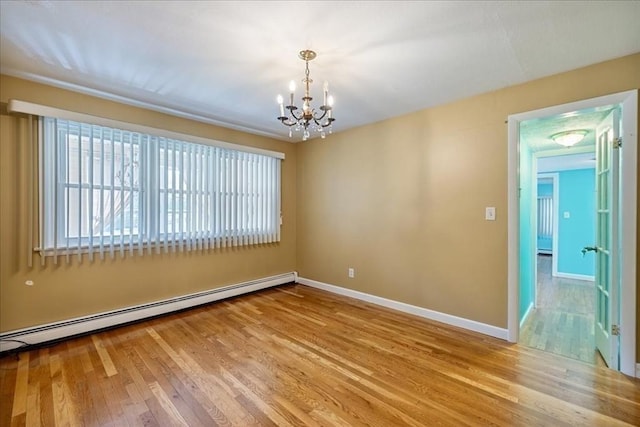 7 Wilbur Ct, Saugus, MA 01906 - unfurnished room with a baseboard heating unit, a chandelier, wood finished floors, and baseboards