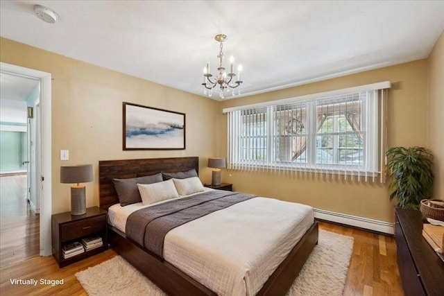 7 Wilbur Ct, Saugus, MA 01906 - bedroom with a baseboard radiator, a chandelier, light wood-style floors, and baseboards
