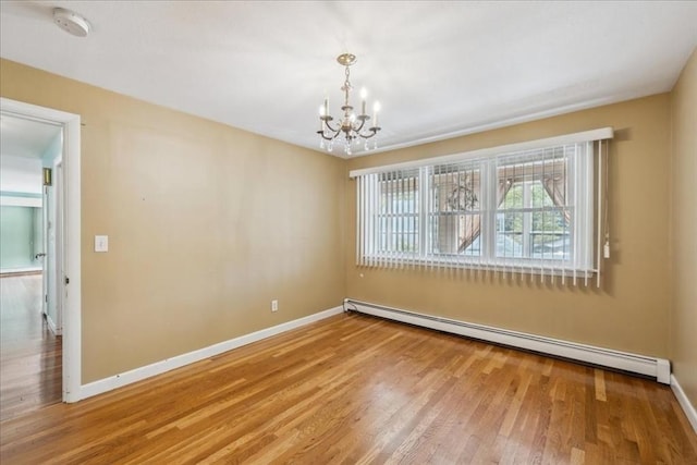 7 Wilbur Ct, Saugus, MA 01906 - unfurnished room with a baseboard radiator, a chandelier, wood finished floors, baseboards, and a smoke detector
