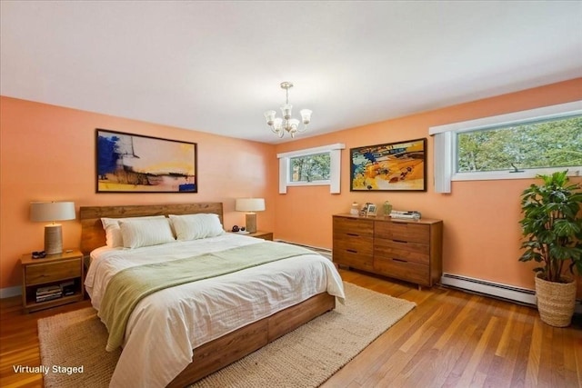 7 Wilbur Ct, Saugus, MA 01906 - bedroom featuring a chandelier, light wood-style flooring, baseboard heating, and a baseboard heating unit