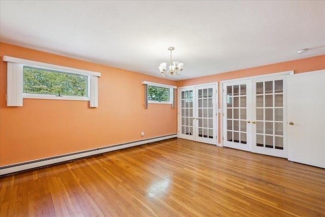 7 Wilbur Ct, Saugus, MA 01906 - spare room with french doors, wood finished floors, a chandelier, and a baseboard radiator