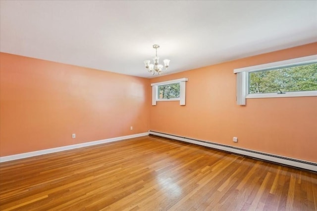 7 Wilbur Ct, Saugus, MA 01906 - spare room featuring a chandelier, a baseboard heating unit, light wood-type flooring, and baseboards