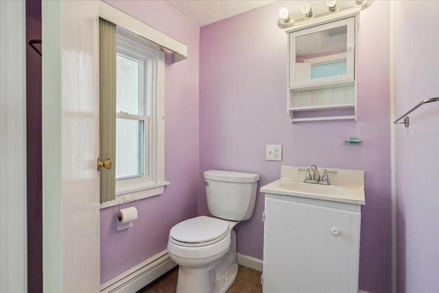 7 Wilbur Ct, Saugus, MA 01906 - half bathroom with toilet, vanity, a baseboard heating unit, and baseboards