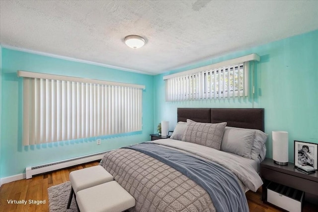 7 Wilbur Ct, Saugus, MA 01906 - bedroom featuring a baseboard heating unit, wood finished floors, a textured ceiling, and baseboards