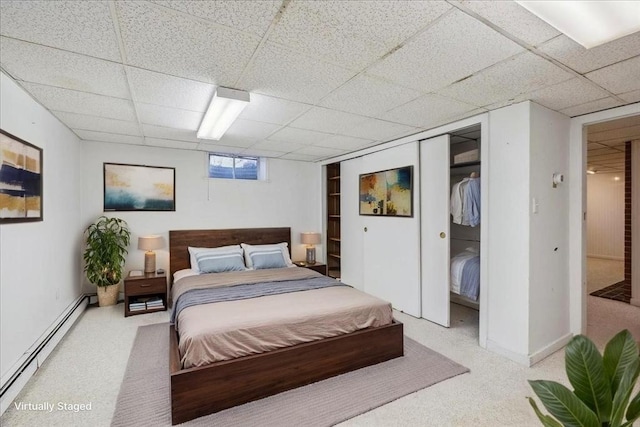 7 Wilbur Ct, Saugus, MA 01906 - bedroom featuring a baseboard heating unit, a drop ceiling, light carpet, and a closet