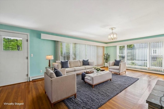 7 Wilbur Ct, Saugus, MA 01906 - living area with a baseboard radiator, wood finished floors, and a chandelier