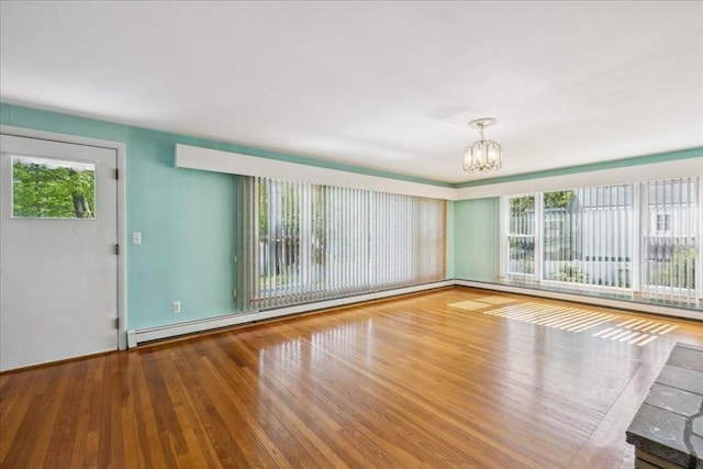 7 Wilbur Ct, Saugus, MA 01906 - unfurnished room with baseboard heating, a chandelier, and wood finished floors