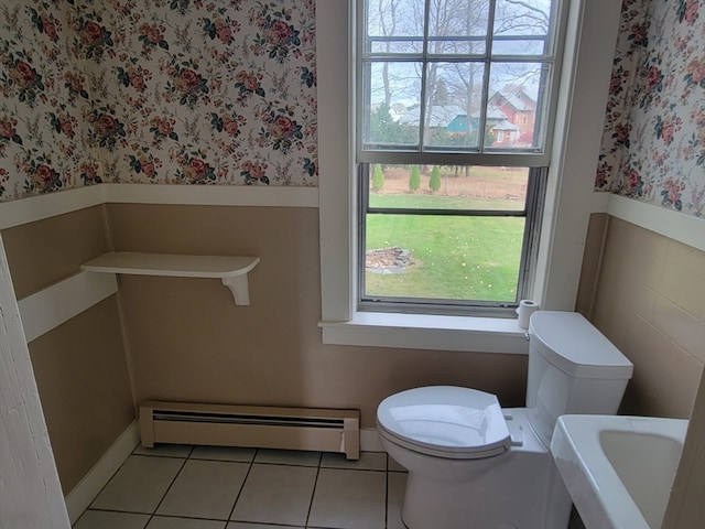 bathroom with sink, tile patterned floors, toilet, and a baseboard heating unit