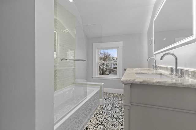 full bath with tile patterned floors, baseboards, a bath, and vanity