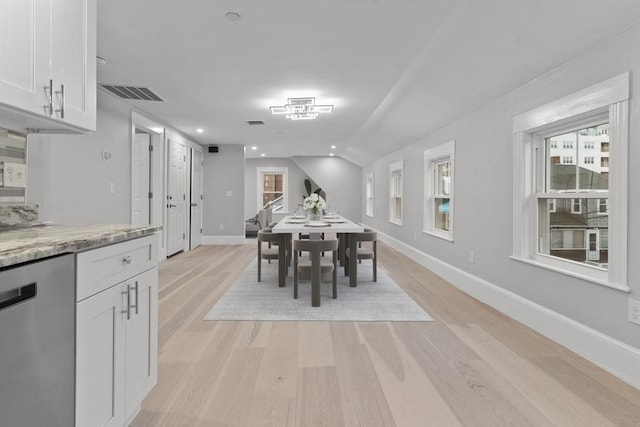 dining area featuring baseboards, visible vents, plenty of natural light, and light wood-type flooring