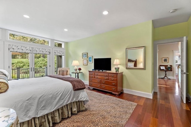 bedroom with access to exterior, baseboards, wood finished floors, french doors, and recessed lighting