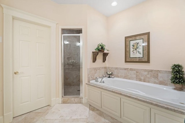 bathroom with a stall shower and a bath