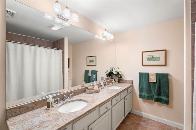 full bathroom featuring tile patterned flooring, double vanity, baseboards, and curtained shower