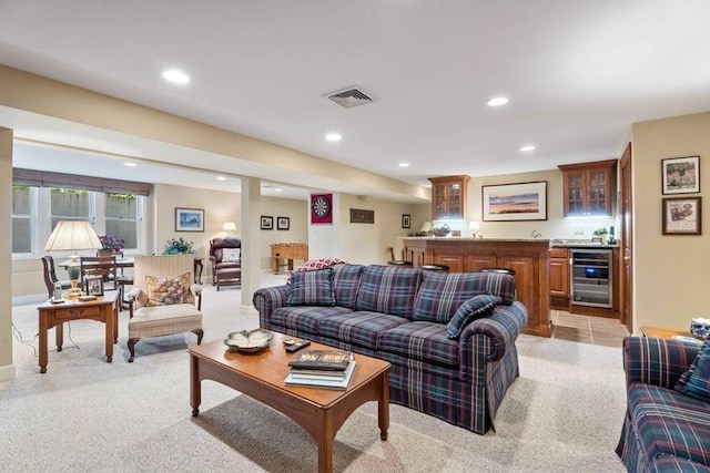 living room featuring wine cooler, bar with sink, light carpet, and recessed lighting
