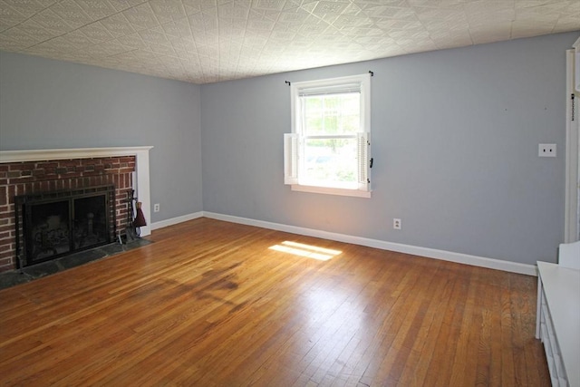 1 Stratford Rd, Holyoke, MA 01040 - unfurnished living room with baseboards, hardwood / wood-style floors, and a fireplace