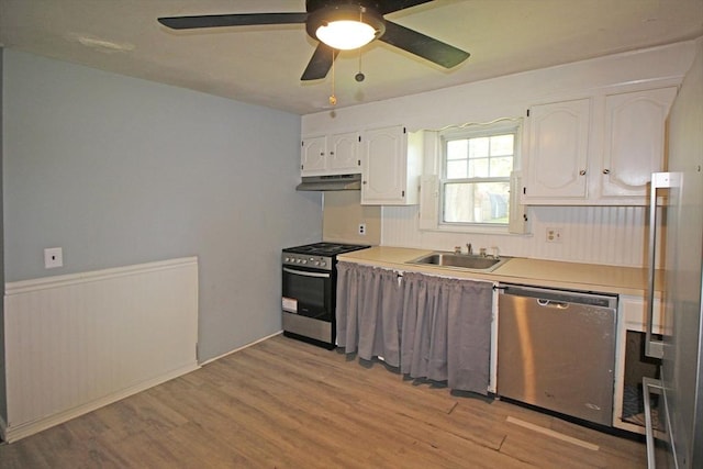 1 Stratford Rd, Holyoke, MA 01040 - kitchen with appliances with stainless steel finishes, a sink, under cabinet range hood, white cabinetry, and light wood finished floors