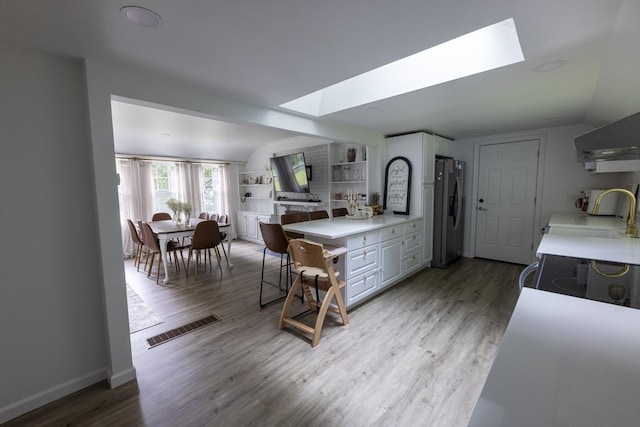 400 Loomis St, Westfield, MA 01085 - kitchen with stainless steel refrigerator with ice dispenser, a sink, a skylight, and light countertops
