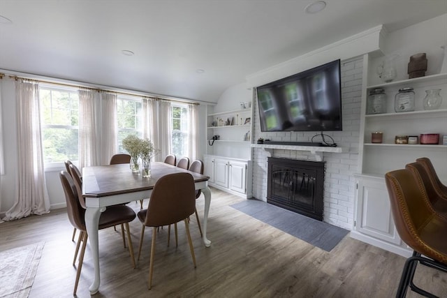400 Loomis St, Westfield, MA 01085 - dining area with built in shelves, healthy amount of natural light, light wood-type flooring, and a brick fireplace