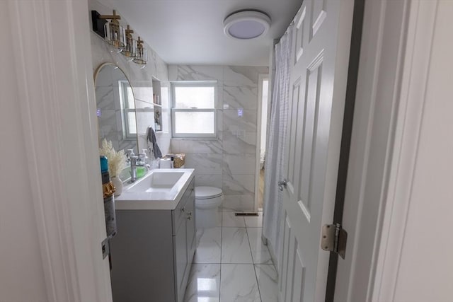 400 Loomis St, Westfield, MA 01085 - full bath featuring vanity, a marble finish shower, toilet, marble finish floors, and tile walls
