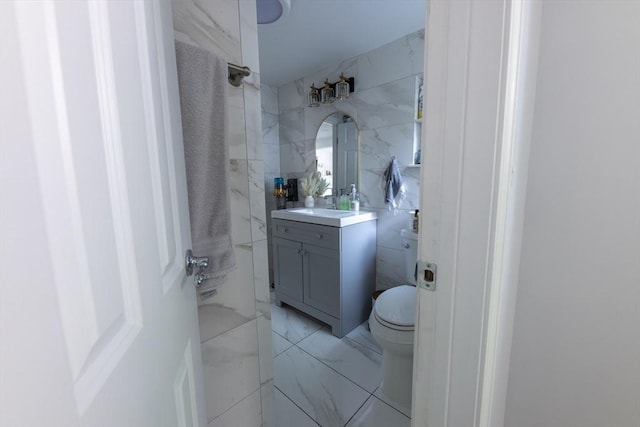 400 Loomis St, Westfield, MA 01085 - bathroom featuring marble look tiles, toilet, vanity, tile walls, and a shower