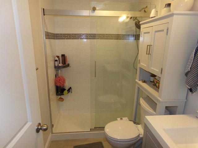 bathroom featuring walk in shower, vanity, and toilet