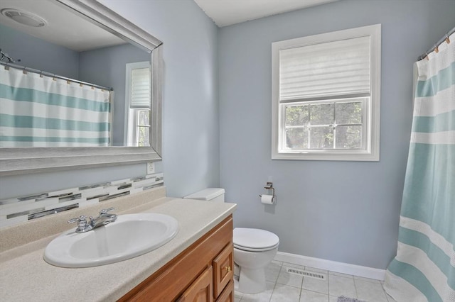 bathroom featuring toilet, visible vents, tile patterned flooring, baseboards, and vanity