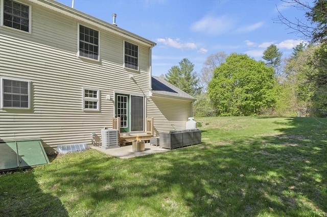 rear view of house with a yard, entry steps, a patio area, and central AC