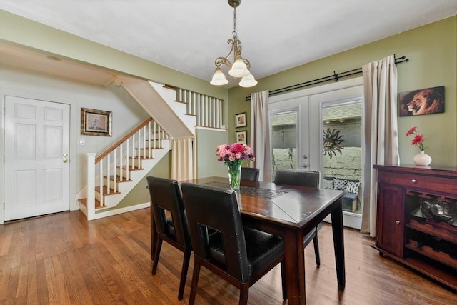 43 Endicott St Unit 43, Salem, MA 01970 - dining area featuring a chandelier, stairway, wood finished floors, and french doors