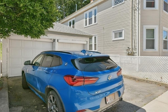 43 Endicott St Unit 43, Salem, MA 01970 - view of side of home with a shingled roof and a garage