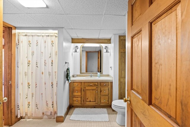 111 Esta Rd, Plymouth, MA 02360 - full bath with toilet, vanity, a shower with curtain, a paneled ceiling, and tile patterned floors