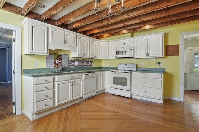 270 Main St, Oxford, MA 01540 - kitchen with white appliances, white cabinets, a sink, backsplash, and baseboards
