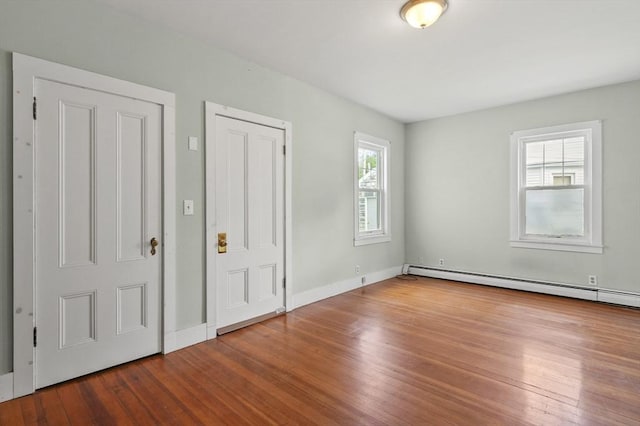 270 Main St, Oxford, MA 01540 - unfurnished bedroom featuring wood finished floors, a baseboard radiator, and baseboards