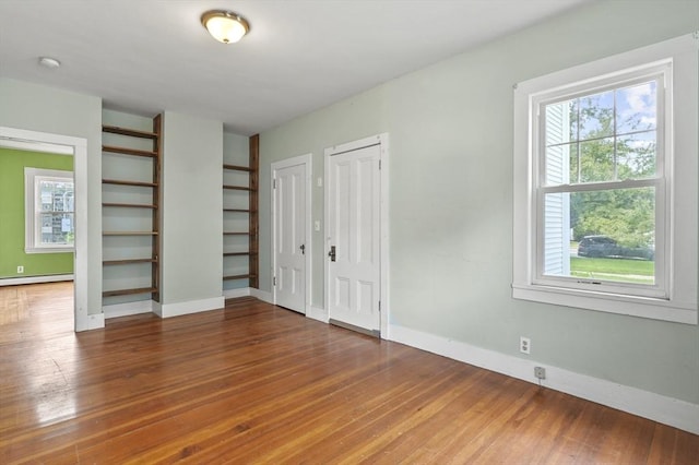 270 Main St, Oxford, MA 01540 - unfurnished bedroom with multiple closets, wood finished floors, baseboards, and a baseboard heating unit