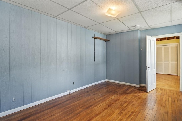 270 Main St, Oxford, MA 01540 - spare room featuring hardwood / wood-style floors, wooden walls, baseboards, and a drop ceiling