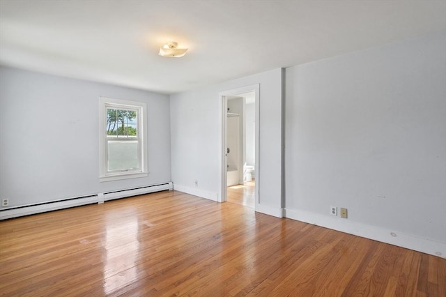 270 Main St, Oxford, MA 01540 - empty room with wood finished floors, a baseboard radiator, and baseboards