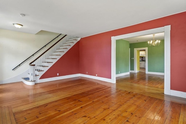 270 Main St, Oxford, MA 01540 - unfurnished living room featuring stairway, wood-type flooring, a chandelier, and baseboards