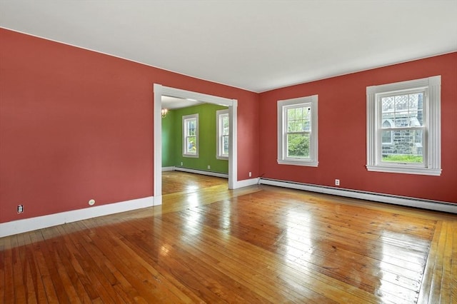 270 Main St, Oxford, MA 01540 - empty room with baseboard heating, wood-type flooring, and baseboards