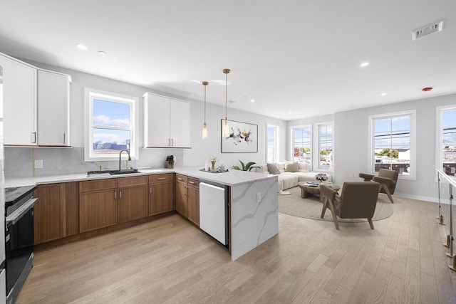 kitchen with dishwashing machine, light wood-style flooring, visible vents, open floor plan, and electric stove