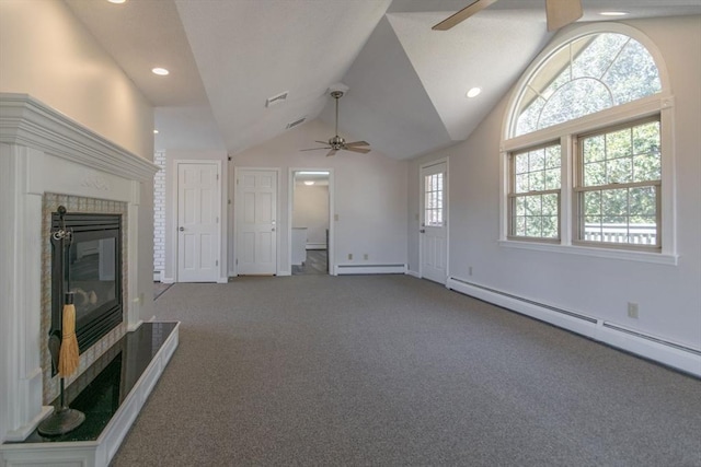 unfurnished living room with a baseboard radiator, lofted ceiling, a tile fireplace, ceiling fan, and baseboard heating