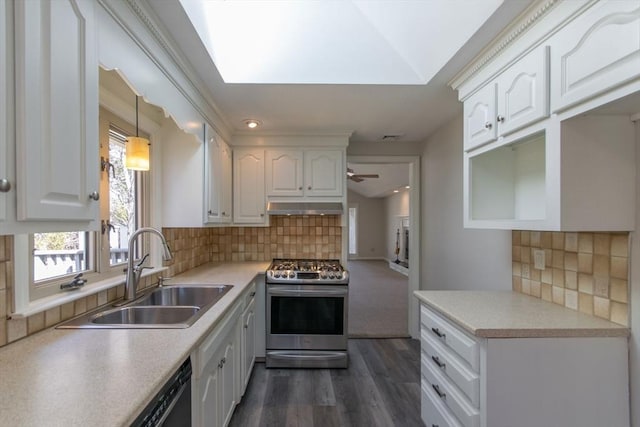 kitchen featuring a sink, white cabinets, under cabinet range hood, and stainless steel gas range oven