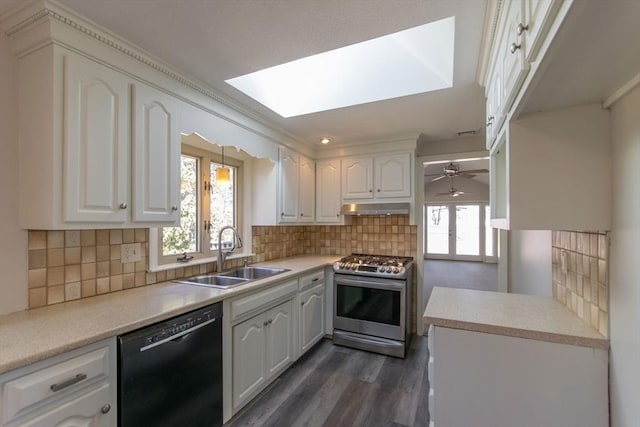 kitchen with white cabinetry, a sink, under cabinet range hood, dishwasher, and gas range