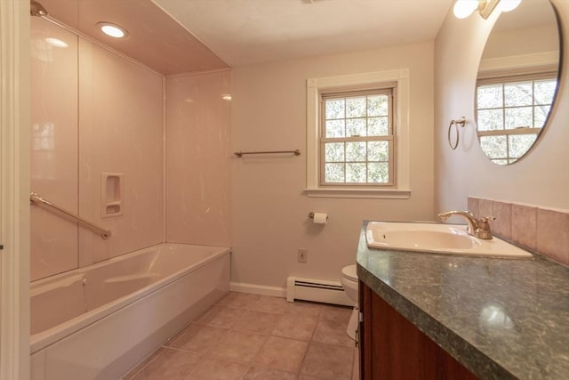 bathroom featuring baseboard heating, a healthy amount of sunlight, toilet, and vanity