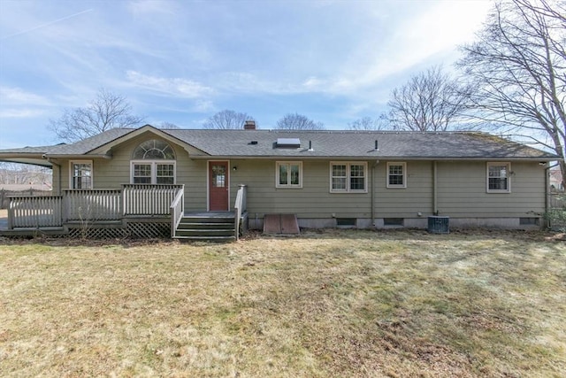 back of house with central air condition unit, a wooden deck, roof with shingles, a chimney, and a yard