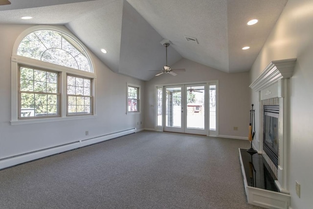 unfurnished living room featuring visible vents, a baseboard heating unit, a ceiling fan, and vaulted ceiling