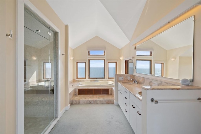 full bathroom featuring double vanity, vaulted ceiling, a shower stall, a sink, and a bath