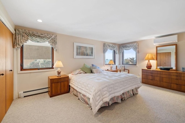 bedroom featuring baseboard heating, a wall unit AC, a closet, and light colored carpet