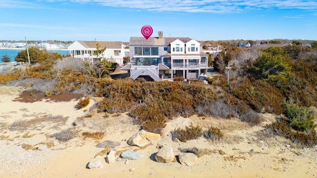 back of property with a water view