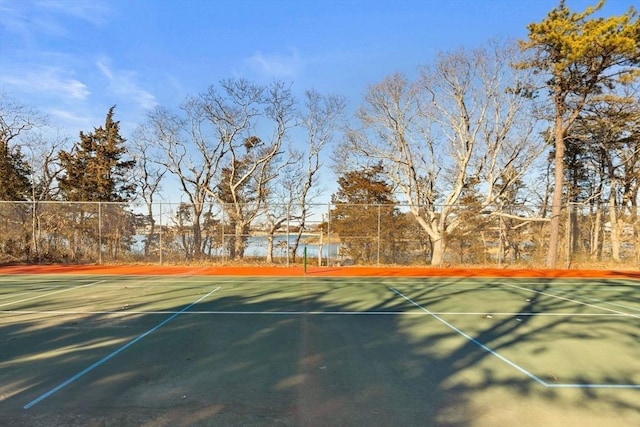 view of sport court featuring fence